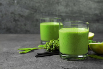 Tasty fresh kale smoothie on grey table