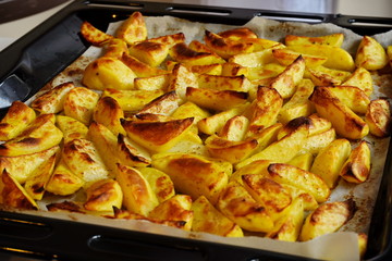 A pile of fresh delicious yellow baked or stewed potatoes with h