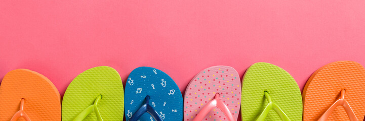 a lot of flip flop colored sandals, summer vacation on colored background, banner copy space top...