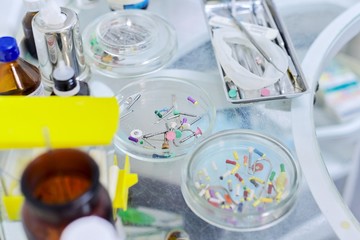 Close-up work at dentist desk, dental composite sealing materials instruments tools