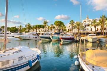 Fototapeta na wymiar Boats and yachts moored in the marina of Cala d'Or, Mallorca, Spain.
