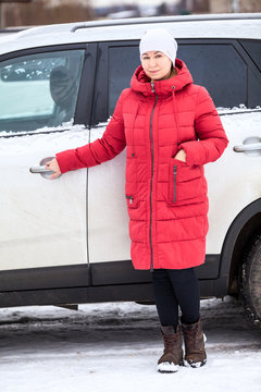 Woman A Driver Opening Dooor Of Her Minivan, Full Length Portrait, Dressed Red Down Jacket