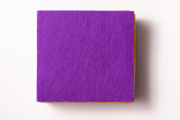 Flatlay a stack of felt pieces with a purple top on a white background