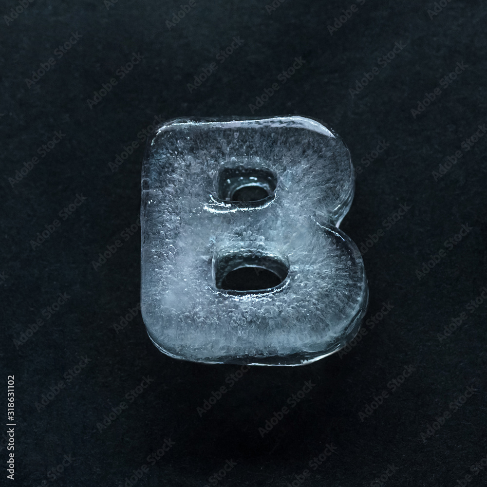 Fototapete melting speech. alphabet's shiny and well-structured letters made out of ice isolated on dark studio
