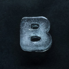 Melting speech. Alphabet's shiny and well-structured letters made out of ice isolated on dark...