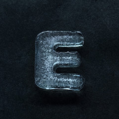 Melting speech. Alphabet's shiny and well-structured letters made out of ice isolated on dark...