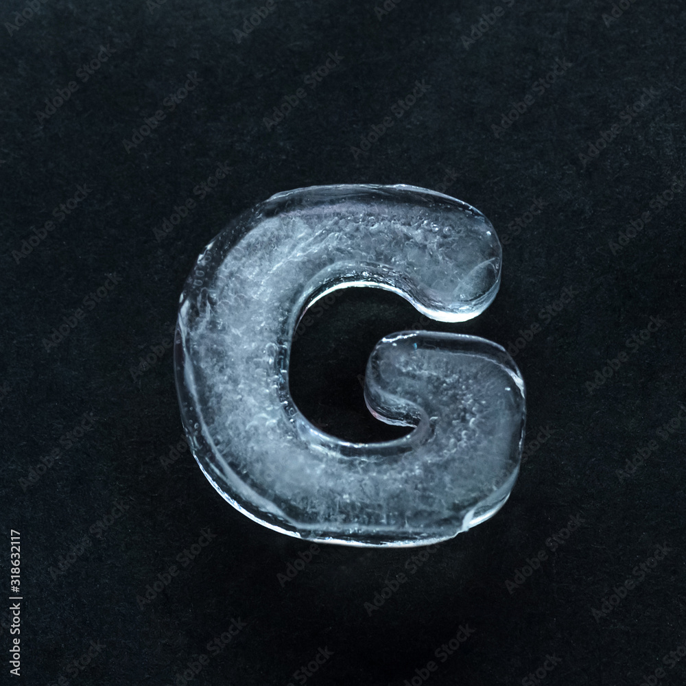 Fototapete melting speech. alphabet's shiny and well-structured letters made out of ice isolated on dark studio