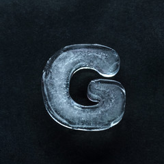 Melting speech. Alphabet's shiny and well-structured letters made out of ice isolated on dark...