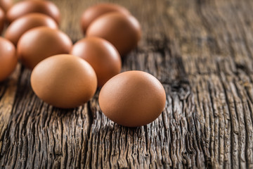Fresh raw eggs on rustic wooden table