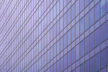 Fototapeta na wymiar Glass blue square Windows of facade modern city business building skyscraper. Modern apartment buildings in new neighborhood. Abstract architecture. Windows of a building, texture. 