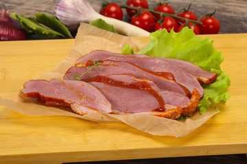 Sliced smoked duck breast served salad