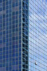 Fototapeta na wymiar Abstract architecture. Glass blue square Windows of facade modern city business building skyscraper. The texture of the windows of the building. 