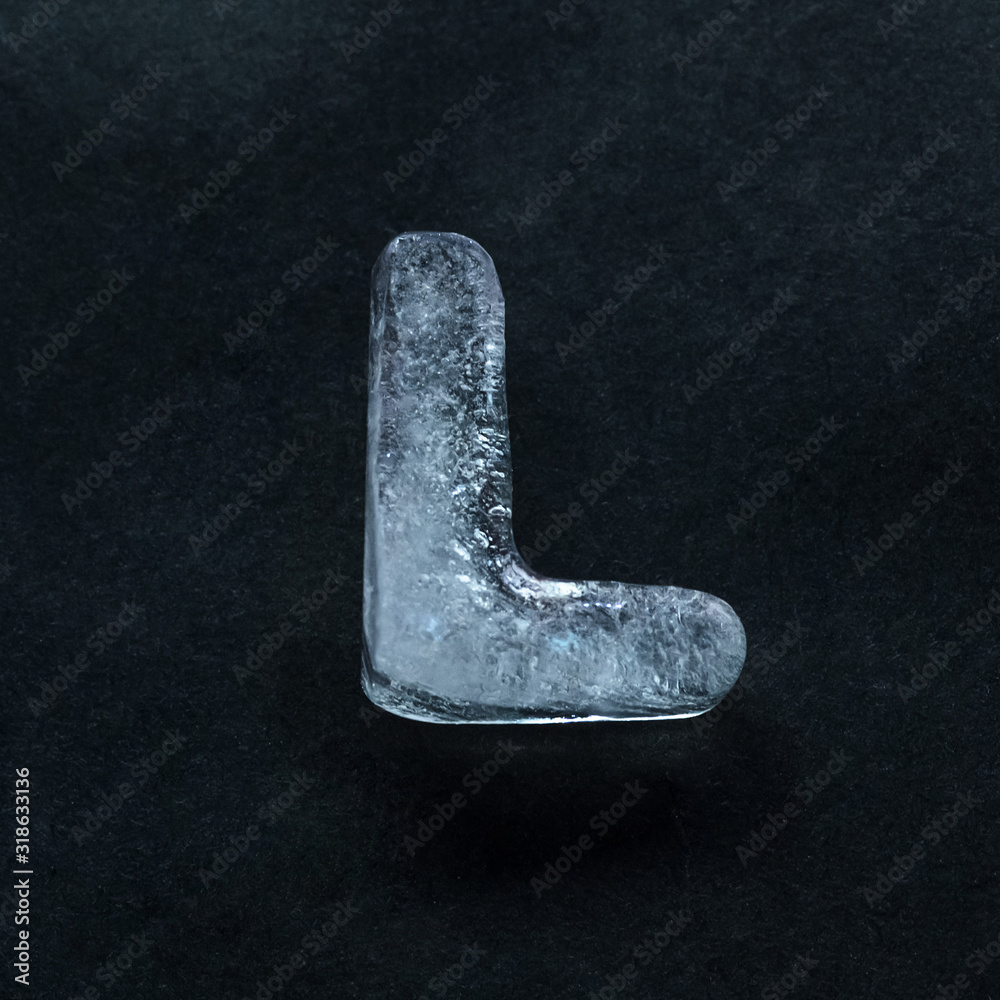 Fototapete melting speech. alphabet's shiny and well-structured letters made out of ice isolated on dark studio