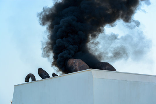 Ship discharging black smoke from the chimney