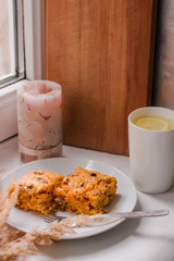 pie on a white plate and lemon tea on the kitchen table