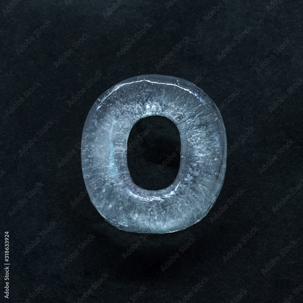Fototapete melting speech. alphabet's shiny and well-structured letters made out of ice isolated on dark studio