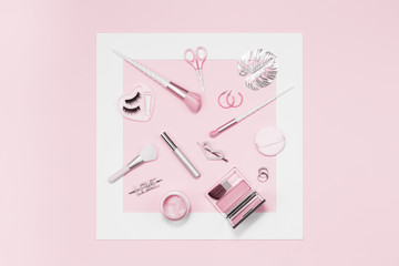 Tender pink monochrome feminine makeup tools and silver accessories framed. brushes eye lashes mascara on candy pink. Flat lay, birthday beauty cosmetics blogger advert concept. Heart, love hair clips