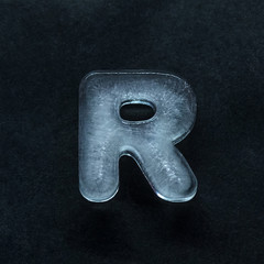 Melting speech. Alphabet's shiny and well-structured letters made out of ice isolated on dark...