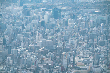 Naklejka na ściany i meble dust during daytime in a very polluted city - in this case Tokyo, Japan. Cityscape of buildings with bad weather from Fine Particulate Matter. Air pollution.