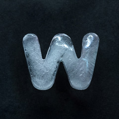 Melting speech. Alphabet's shiny and well-structured letters made out of ice isolated on dark...