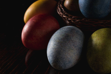 Multi-colored bright easter eggs. Easter. Easter eggs on a dark wooden background Easter background. Easter symbol Easter greetings Christ is risen Copyspace close-up