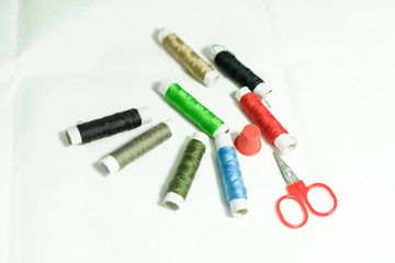 Fototapeta na wymiar spools of multi-colored threads and scissors