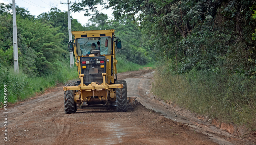 Wall mural roadworks machine in brasil working on gravel road.