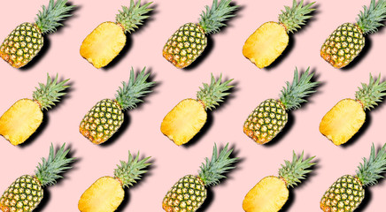 Creative pattern of fruit whole and slice pineapples with shadows on a soft pink color summer background. Clipping Path.