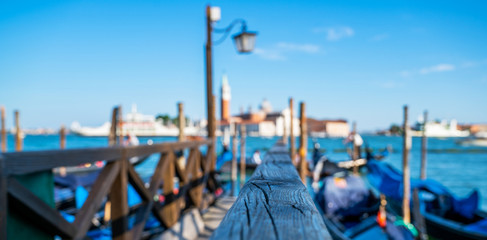 Fototapeta premium Gondolas moored by Saint Mark square. Old pier. Architecture and landmarks of Venice. Vacation and holidays in Italy and Europe concept.