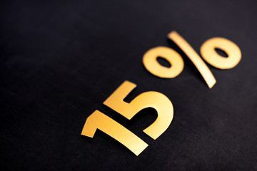 golden 15 percent signs on black background