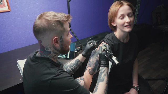 Video of young master getting tattoo of snake in studio