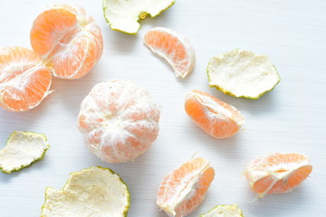 Natural, whole, chopped tangerines on wooden background