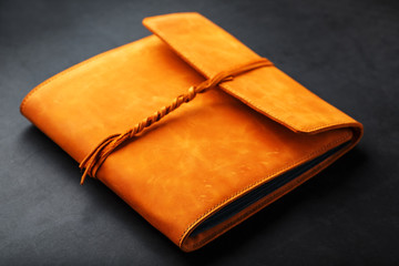 The album cover is made of brown genuine leather, handmade on a black background.