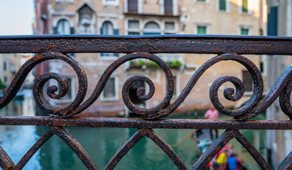 Forged decorative aged rusty metal grid grille fence gate detail, Venice, Italy. Classic ornament. Historical city elements.