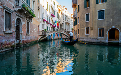 Fototapeta na wymiar View of the canal with gondolas and old buildings in Venice, Italy. Venice is a popular tourist destination of Europe. Vacation and holidays in Italy and Europe concept.