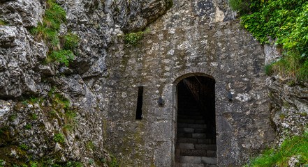 Exterior of the entrance to the citadel of Sisteron, rock fortress in the south of France, Europe. Listed as UNESCO World Heritage Site. Stone wall with traces of weathering and destruction.