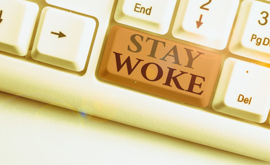 Conceptual hand writing showing Stay Woke. Concept meaning being aware of your surroundings and...