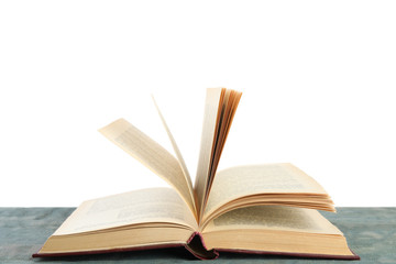 Open old hardcover book on wooden table