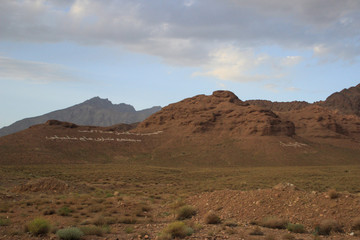 Desert landscape with rocks and geological formations on a hot summer day on the road from Kerman to Mashhad.