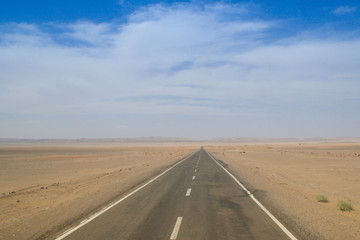 Fototapeta na wymiar Desert landscape with rocks and geological formations on a hot summer day on the road from Kerman to Mashhad.