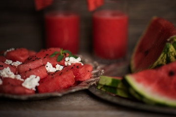 Fresh summer watermelon salad with feta cheese, arugula, onions on rustic background.