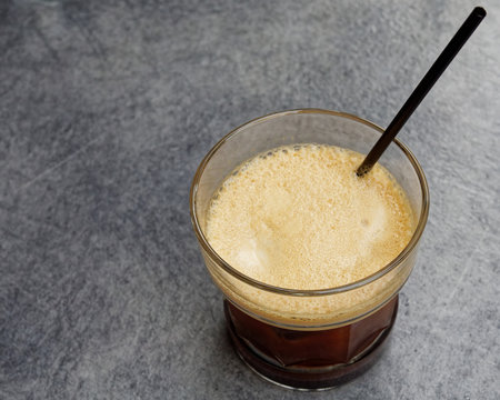 Ice cold espresso coffe glass on grey granite table