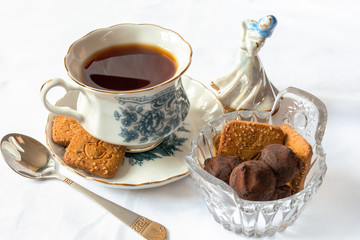Чай. Чайная пара. Хрустальное блюдце с печеньем и конфетами. Фарфоровая статуэтка.  Tea. Tea pair. Crystal saucer with cookies and sweets. Porcelain figurine.