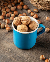 Walnuts in a pot, with hazelnuts in the background