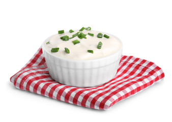 Fresh sour cream with onion and fabric on white background