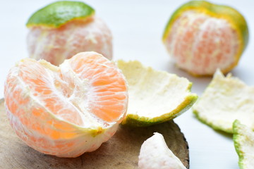  Natural, whole, chopped tangerines on wooden background