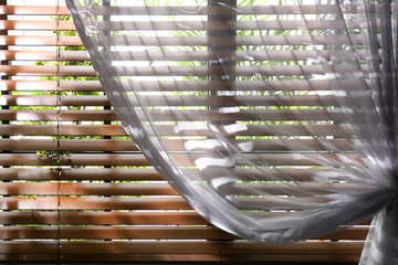 Window with beautiful curtain and blinds, closeup