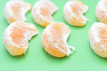  Natural, whole, chopped tangerines on wooden background