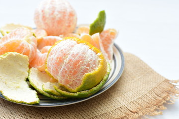  Natural, whole, chopped tangerines on wooden background