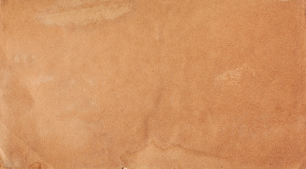 Texture of brown paper with streaks and spots